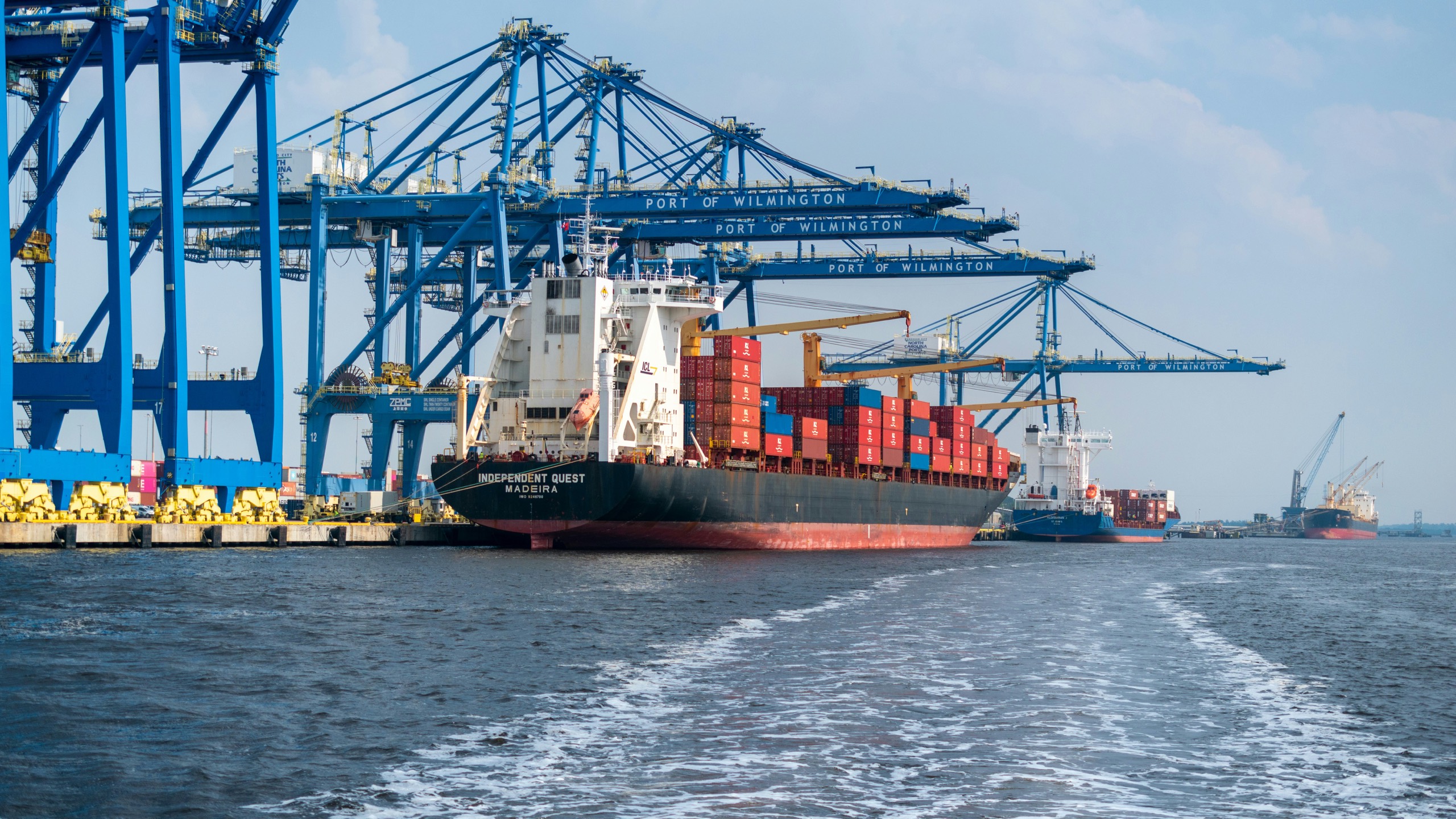 Container vessel alongside under gantry cranes at a working container terminal